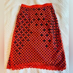 Knee-length skirt with texture and embellishments.